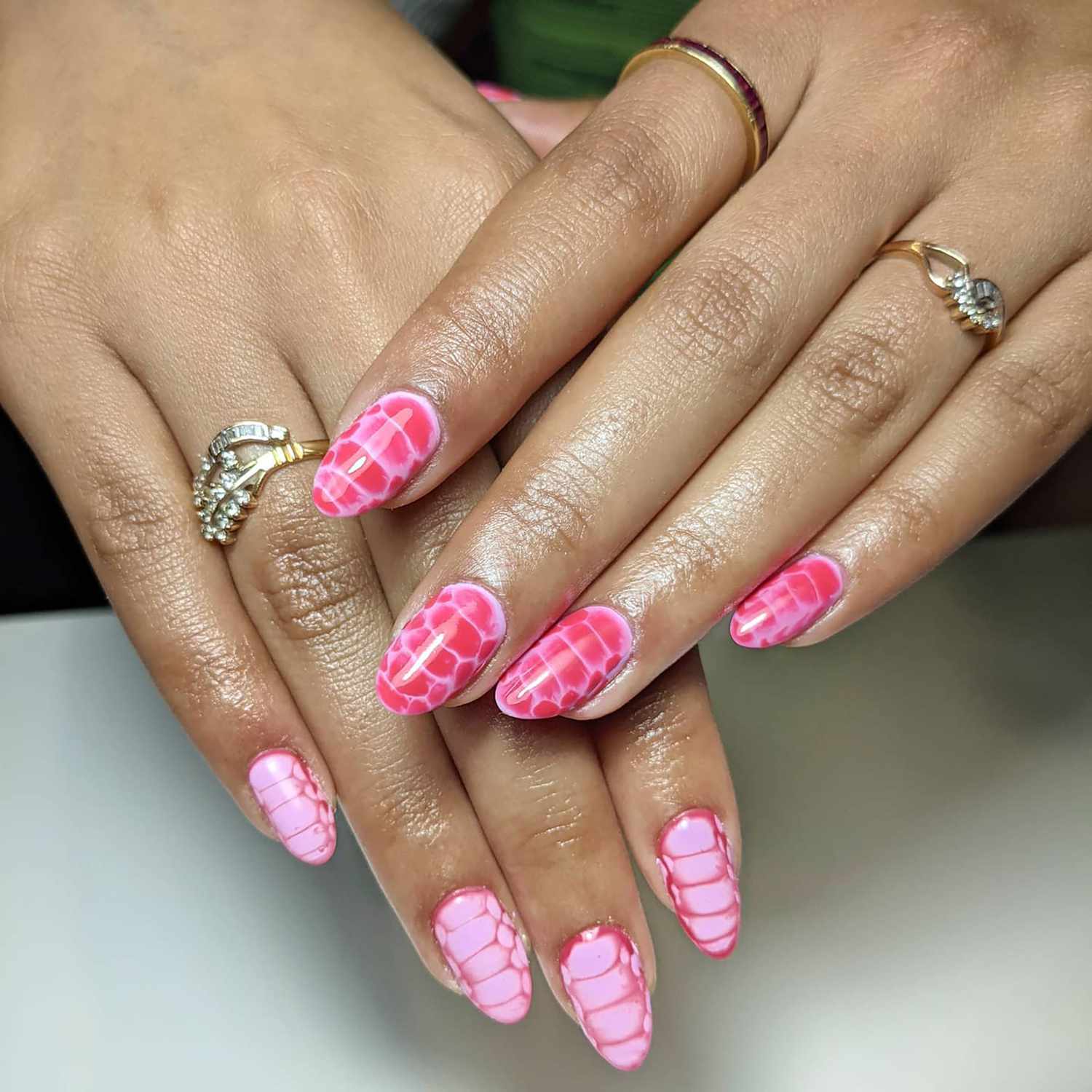 A baby pink manicure with snakeskin motifs