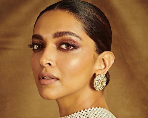 Deepika Padukone with glowing skin and a glam neutral eye makeup look