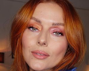 Katie Jane Hughes with velvet eyeshadow (orange on one eye, pink on the other) and pink glossy lips