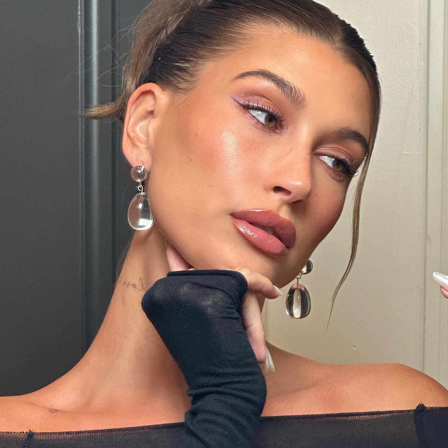 Hailey Bieber wears a radiant makeup look with rosy nude jelly lips