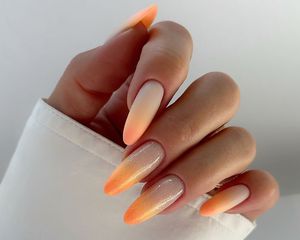 Neutral to peach ombre manicure with shimmer finish accent nails