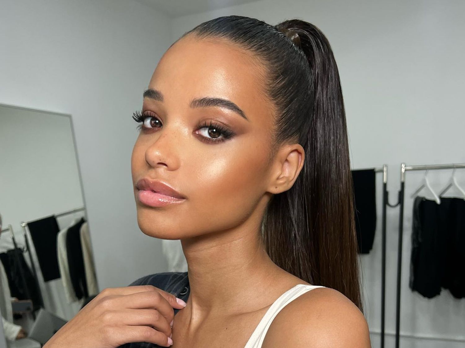 Ella Balinska wears a sleek high ponytail hairstyle and soft glam makeup