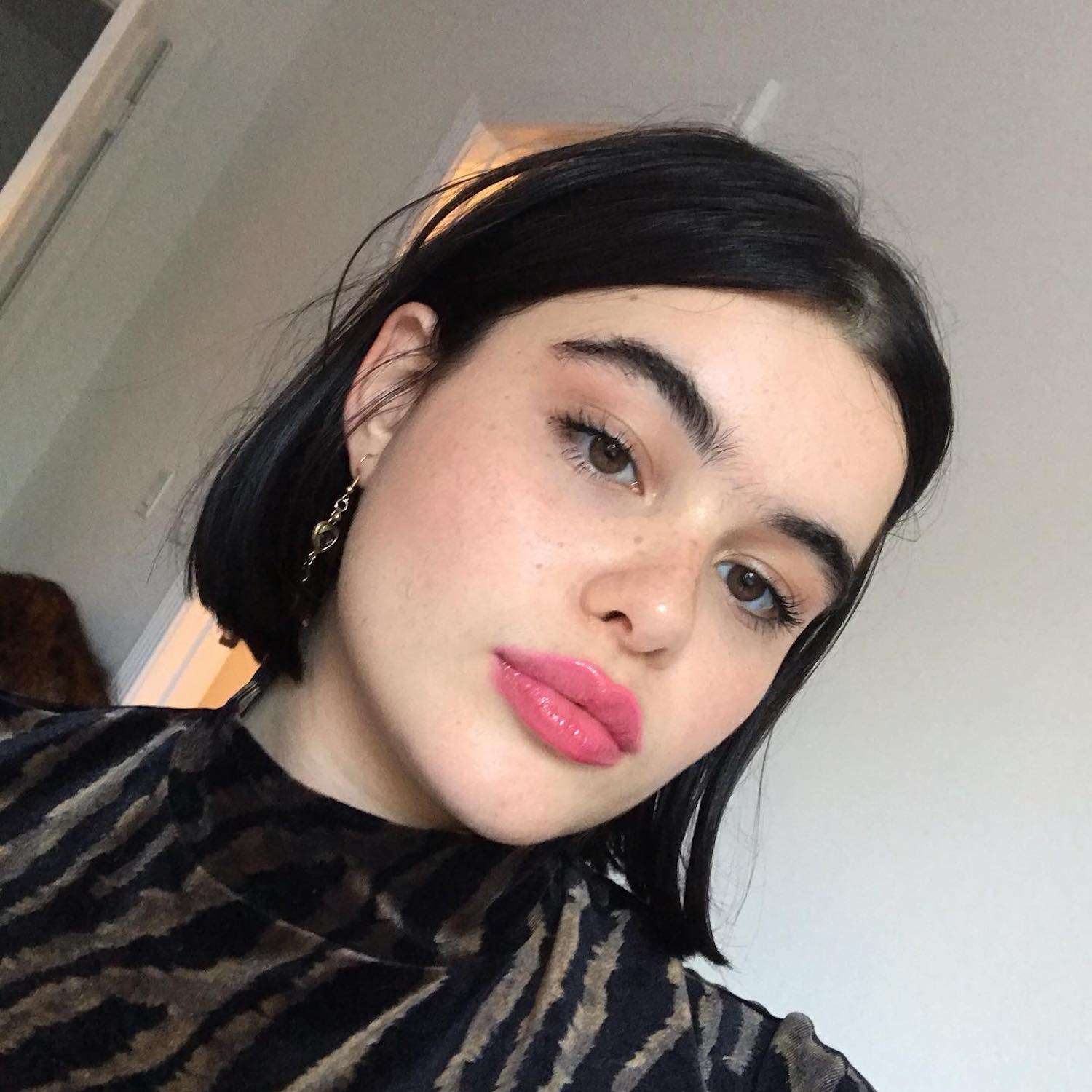 Barbie Ferreira wears a bob hairstyle, minimal makeup, and candy pink jelly lips