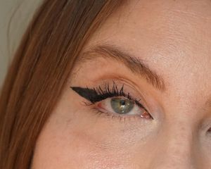 Close up of an eye with angel wing eyeliner makeup