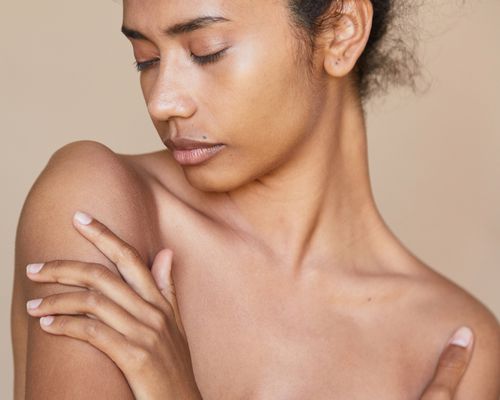 A young woman with glowing shoulders and skin