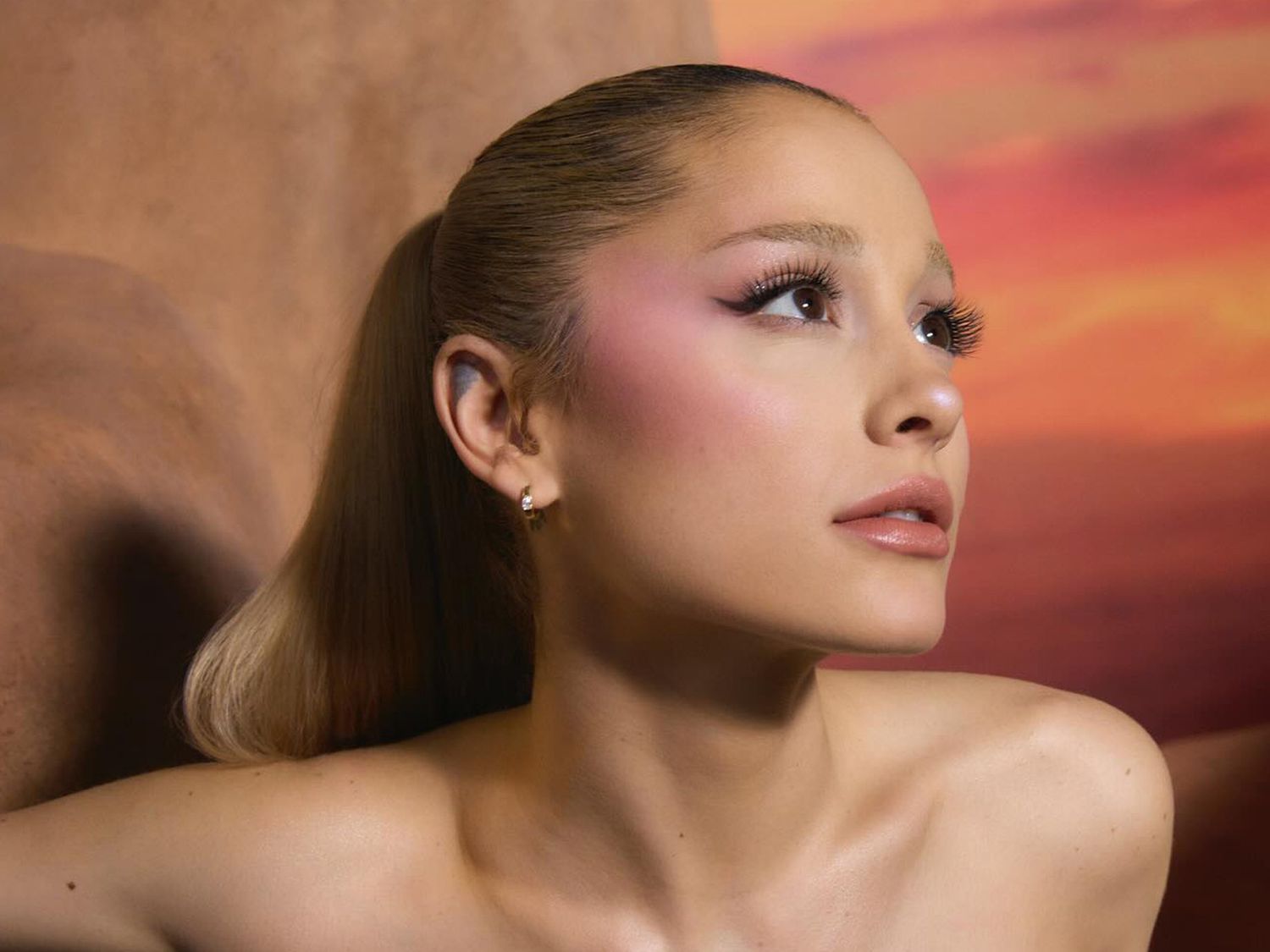 Ariana Grande with blonde hair and pink blush