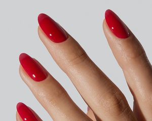 Close up of a short, oval red manicure