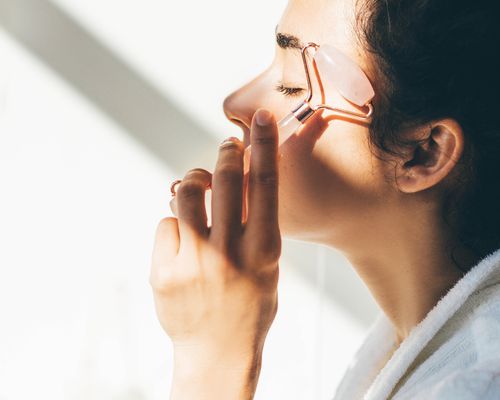 woman using face roller