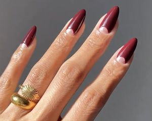 Close up of a berry manicure with pink half moons at the base of the cuticles