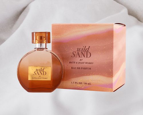 Bath & Body Works Wild Sand Eau De Parfum collaged against white fabric background