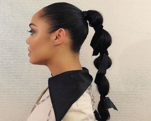 Tessa Thompson in side profile, her hair in a bubble ponytail