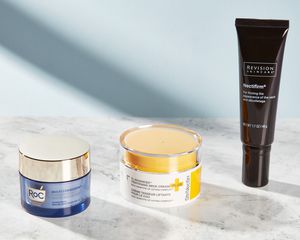 Three neck creams displayed on a marble counter