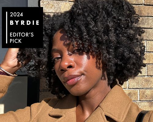 Byrdie editor Jasmine Phillips with glowing skin and voluminous defined curls