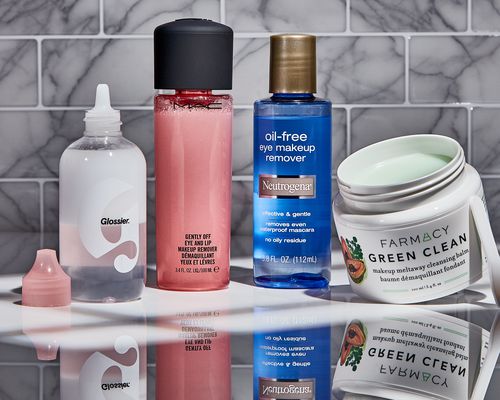 Side-by-side selection of eye makeup remover on a grey counter with a marble tile background 