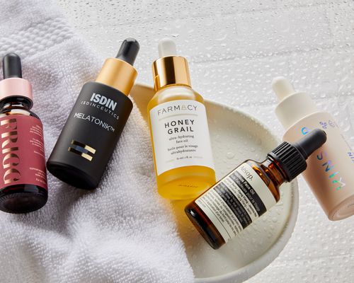 Face oils we recommend on a white tray and white towel