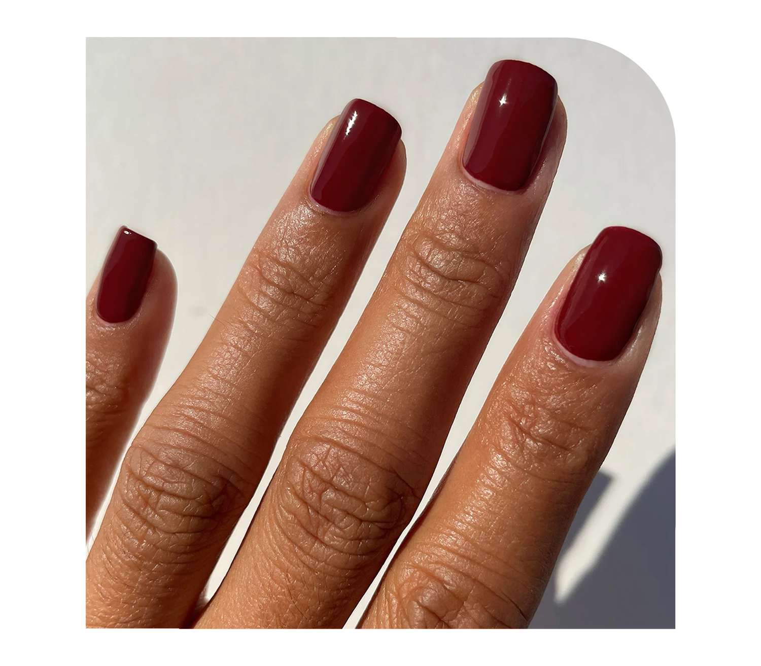 Model wearing red wine nail polish