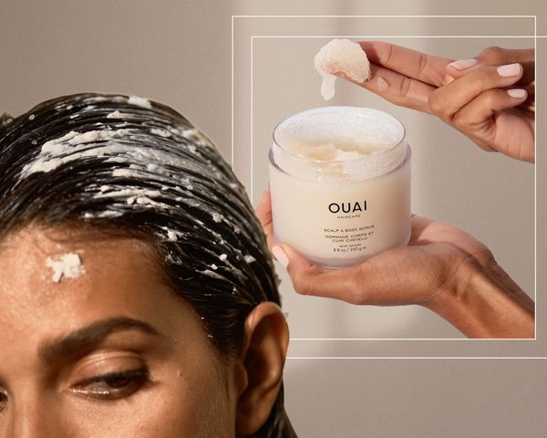 Closeup of person’s wet hair and hand holding Ouai Scalp and Body Scrub collaged on a beige background