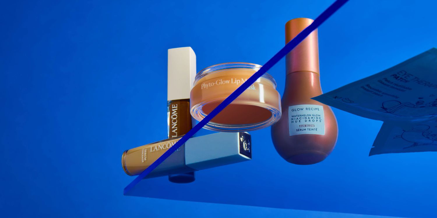 Beauty products on a blue background and plexiglass glow recipe lancome phyto glow