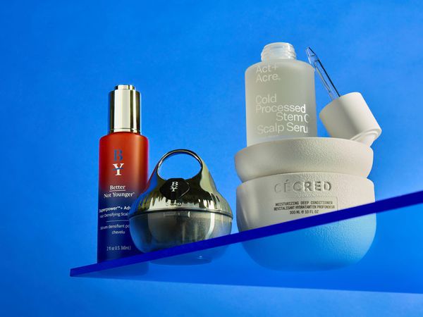 beauty products on a blue background on a plexiglass shelf better not younger cecred act+acre