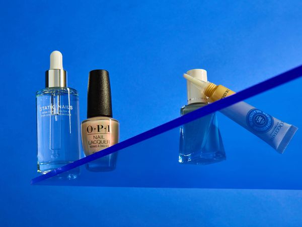 beauty products on a blue background on a plexiglass shelf static nails opi 