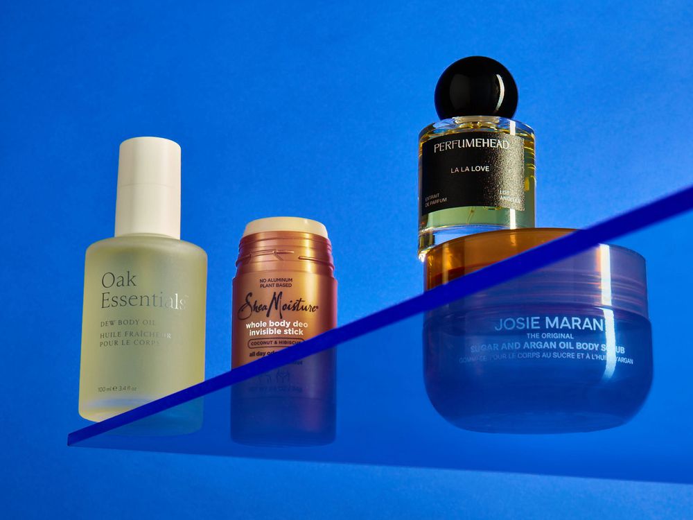 beauty products on a blue background on a plexiglass shelf oak essentials shea moisture josie maran perfumehead