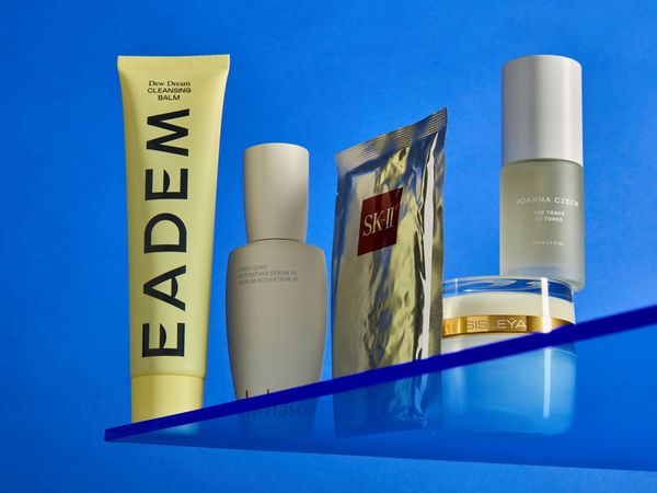 beauty products on a blue background on a plexiglass shelf eadem SK-II joanna czech sisley