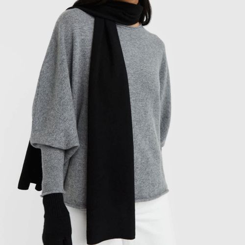 Quince Mongolian Cashmere Scarf in black on model wearing oversized gray sweater