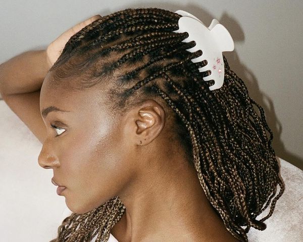 Woman with a half-up, half-down box braid hairstyle