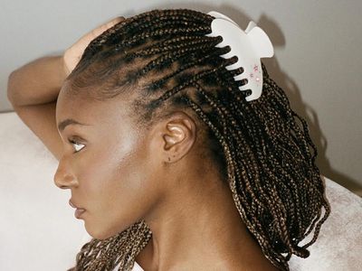 Woman with a half-up, half-down box braid hairstyle