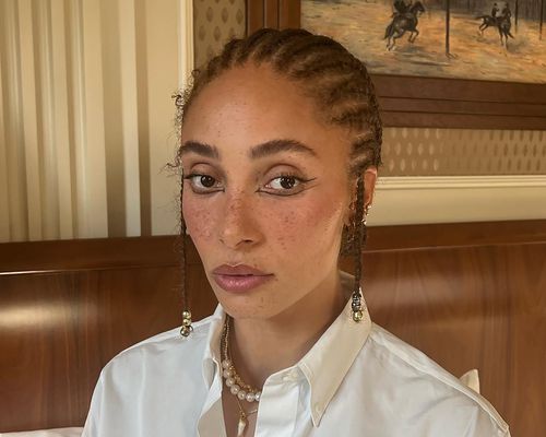 Close up of model Adwoa Aboah, her hair in straight back cornrows with plaits at her ears