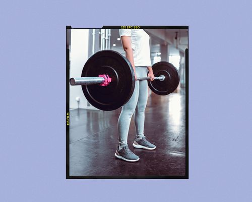 person lifting a barbell weight