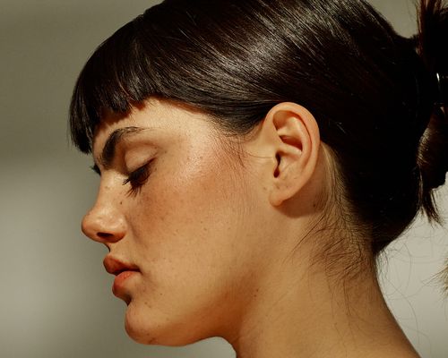 Profile view of a woman, her skin bright and even