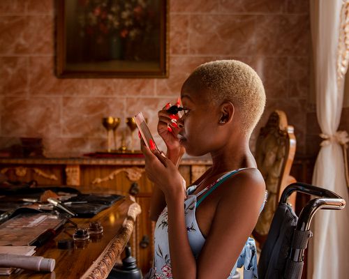 Woman applying make-up at home