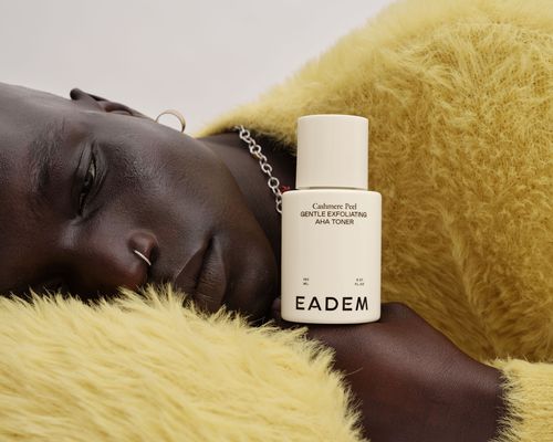 A model with Eadem's Cashmere Peel Toner resting on their hand