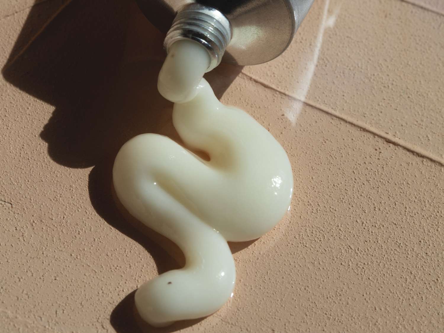 close up of ceramide cream squeezing out of a tube 