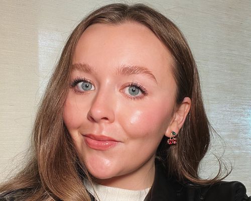 woman with hooded eyes wearing cherry earrings 