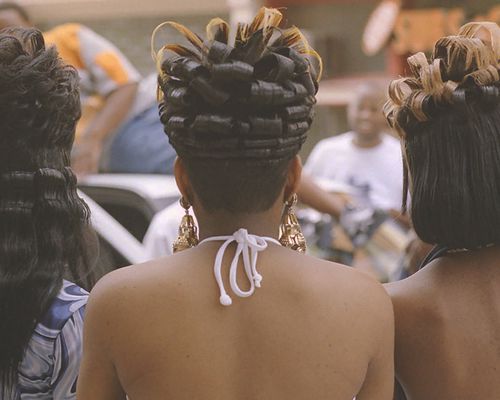 Rear view of a trio of women with curled, hairsprayed hair at Freaknik