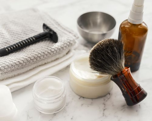 Close-up of shaving equipment on marble table