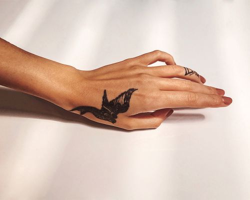 Hand with sparrow tattoo