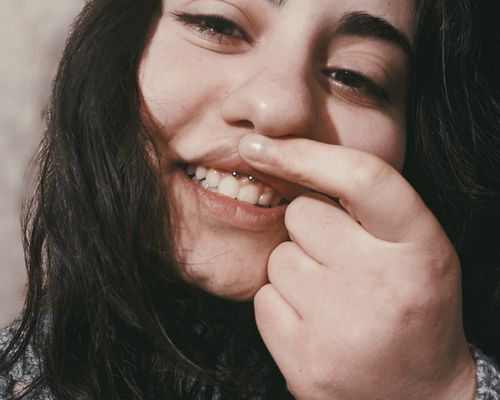 woman showing off inner lip piercing