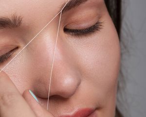 Close-up of woman getting her eyebrows threaded