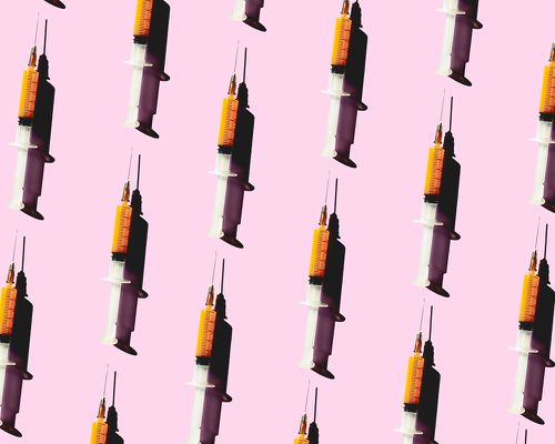 syringes on pink backdrop