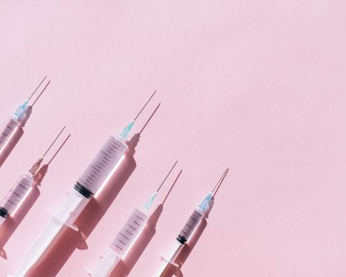 Botox needles on pink background