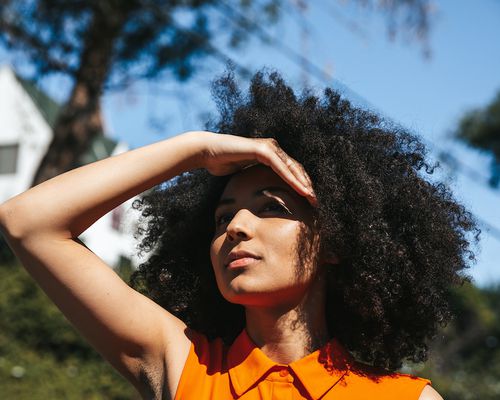 Woman shielding her eyes from the sun