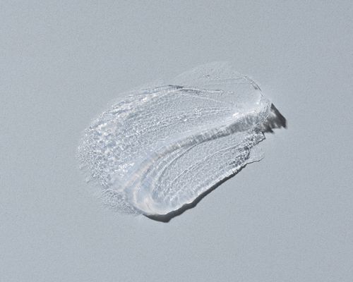 a swatch of petroleum jelly on a gray background