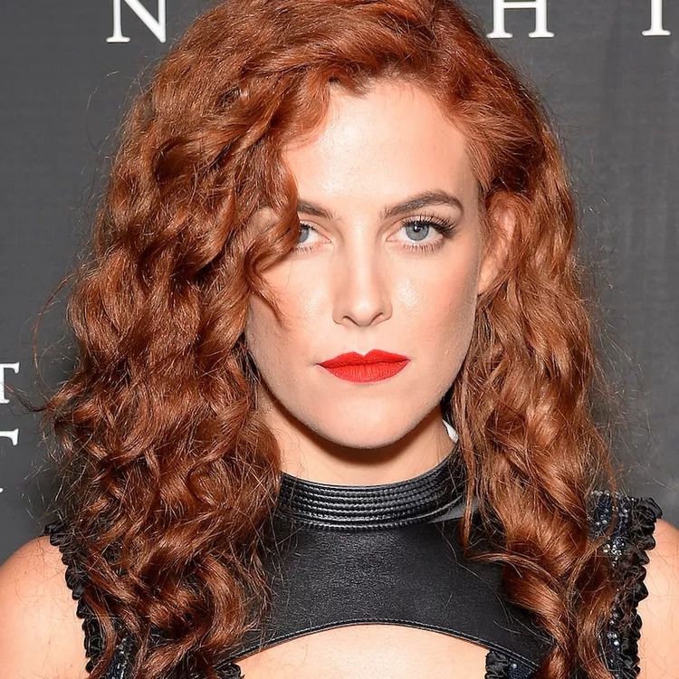 Riley Keough with red curls