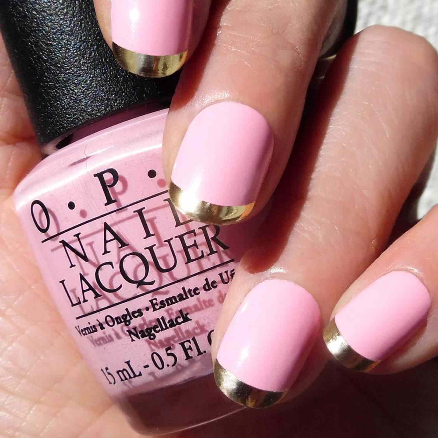 A baby pink French manicure with gold tips