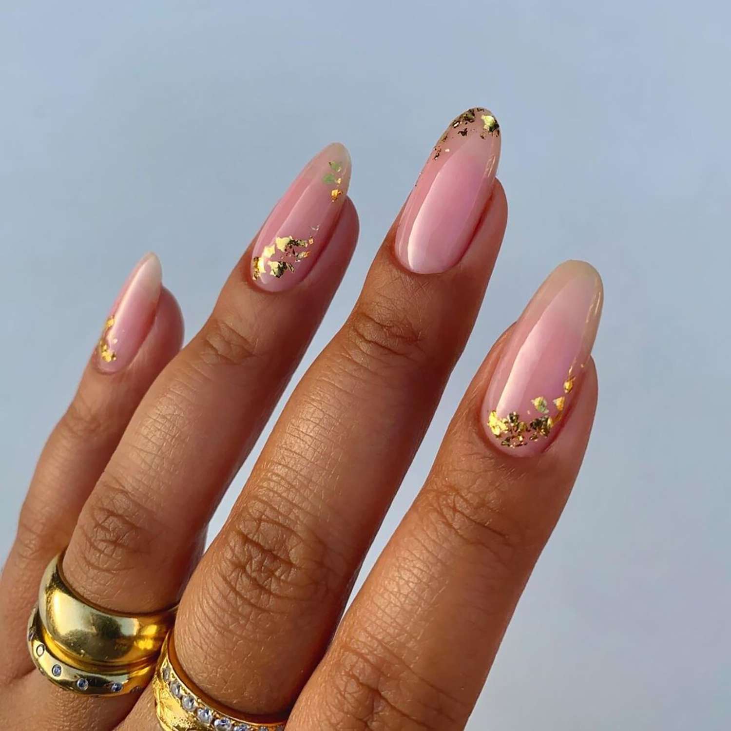 A baby pink mani with gold foil accents