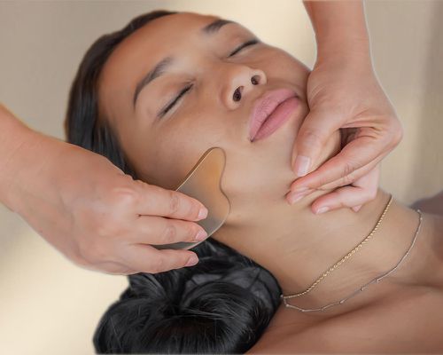 woman getting gua sha facial