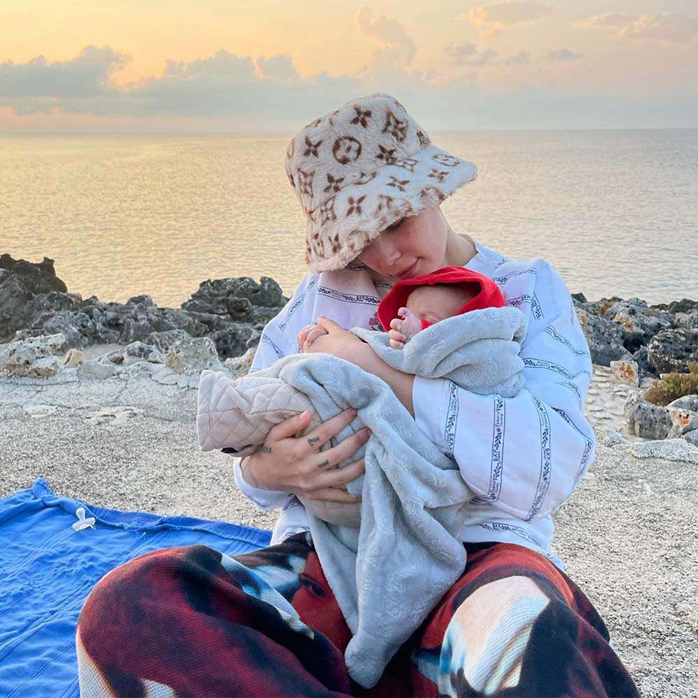 Halsey and her baby on the beach